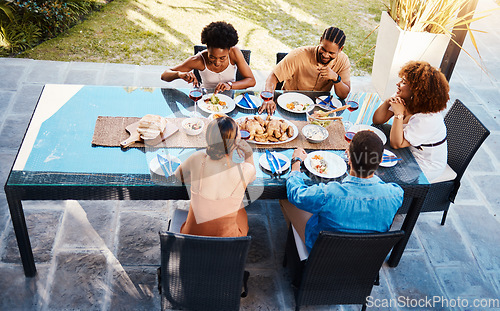 Image of Food, top and people in house backyard to relax on holiday celebration or vacation in summer together. Party, home or happy friends eating to bond at table in conversation for lunch or brunch meal