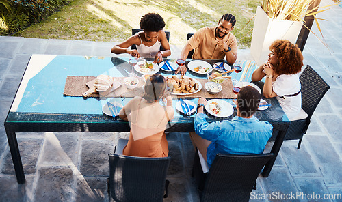 Image of Food, top and friends in house backyard to relax on holiday celebration or vacation in summer together. Party, home or happy people eating to bond at table in conversation for lunch or brunch meal