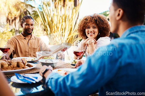 Image of Happy, friends and lunch in a garden with conversation, eating and bonding at a table. Smile, laughing and diversity of a woman and men in a backyard with food, conversation or dinner together