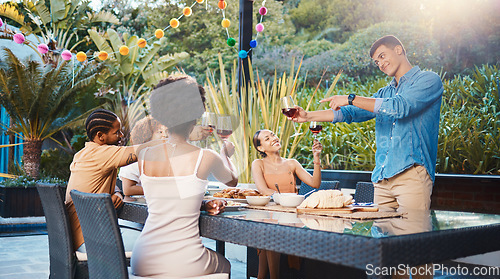 Image of Cheers, celebrate, and friends at dinner in garden at party and diversity, food and wine at outdoor event. Glass toast, men and women at table, fun people with sunset drinks in backyard together.