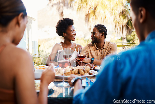 Image of Wine, happy and friends at outdoor restaurant to relax on holiday vacation in summer together. Food, smile or black people eating or bonding at table in conversation on date for lunch or brunch meal