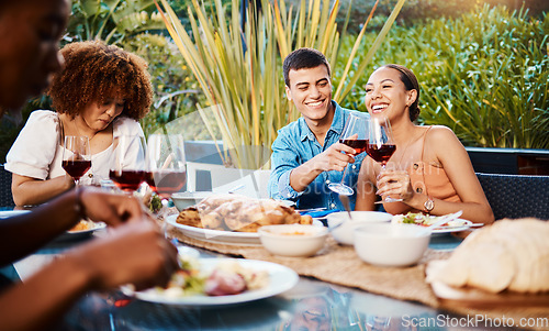 Image of Happy, friends and cheers with wine glass at restaurant, bonding and having fun. Smile, alcohol and group of people toast at dinner party, celebration and drink, eating food and together at table