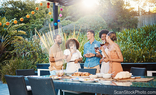 Image of Laughing, diversity and friends at lunch in a garden with drinks, conversation and talking at a party. Happy, alcohol and group of men and women at an outdoor backyard dinner with communication