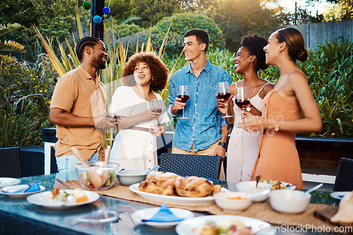 Image of Chat, friends at dinner in garden at party and celebration with diversity, food and wine at outdoor event. Conversation, men and women at table, fun people with sunset drinks in backyard together.