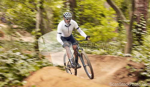 Image of Nature cycling, bicycle and sports man travel, ride and journey on off road path, outdoor challenge or exercise. Fast mountain bike, speed blur and athlete training, fitness and workout in forest