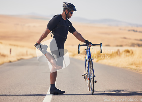 Image of Man, cyclist and stretching on road with bicycle in fitness, training or outdoor sports in countryside. Active male person or athlete in body warm up, leg exercise or preparation in cycling or cardio