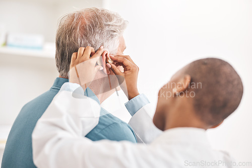 Image of Doctor, helping and man with hearing aid, technology or healthcare or medical device consultation for deaf patient with tinnitus. Listening, test and exam ear tech with nurse or senior male in clinic