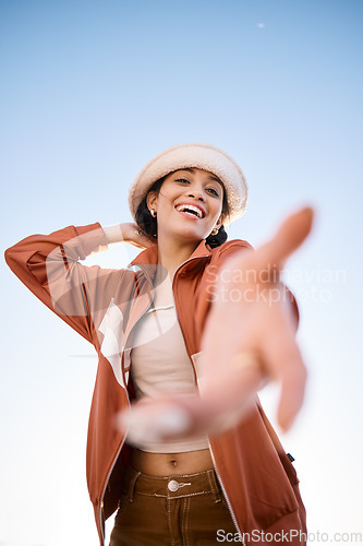 Image of Portrait, woman smile and offer helping hand to welcome outdoor on low angle mockup space. Happy, palm and person giving assistance for support, care or acceptance of handshake sign for invitation