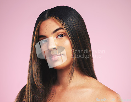 Image of Portrait, hair care and woman with cosmetics, growth and skincare on a pink studio background. Face, person or model with natural beauty, aesthetic and dermatology with wellness and salon treatment