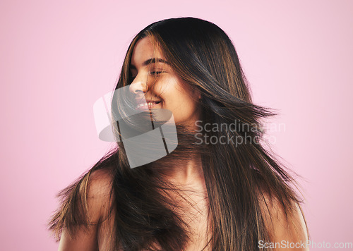 Image of Hair care, smile and woman shaking head in studio, luxury salon treatment and shine with texture. Healthy haircare wellness, beauty aesthetic and cosmetics, happy girl with glow and pink background.