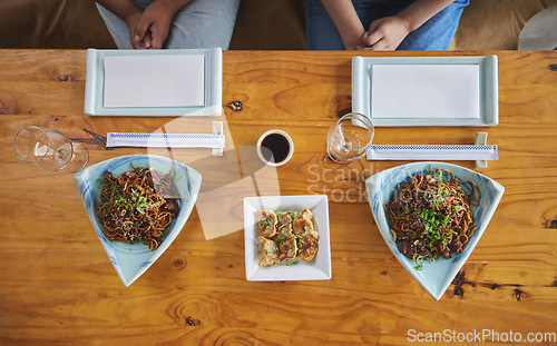 Image of Chinese food, sushi and noodles on a table in a restaurant from above during a date in an asian eatery. Seafood, cuisine in a bowl and a traditional dish for hunger, nutrition or diet closeup