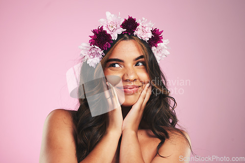 Image of Beauty, flowers and crown on hair of woman in studio for cosmetics, skincare and wellness. Self care, spa treatment and plant with face of person on pink background for spring, glow and makeup