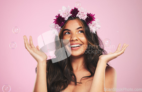 Image of Beauty, flower crown and bubbles with woman in studio for cosmetics, skincare and wellness. Hair care, spa treatment and soap with face of person on pink background for spring, glow and makeup