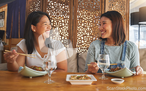 Image of Restaurant, girl friends and laughing with food, noodles and cafe happy from bonding. Asian women, eating and plate together with friendship smile at a table hungry with chopsticks at Japanese bar