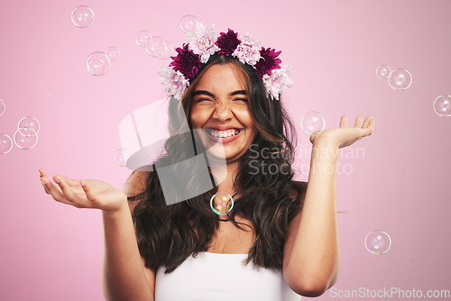 Image of Beauty, flowers and bubbles with portrait of woman in studio for cosmetics, skincare and wellness. Hair care, spa treatment and crown with person on pink background for spring, glow and makeup