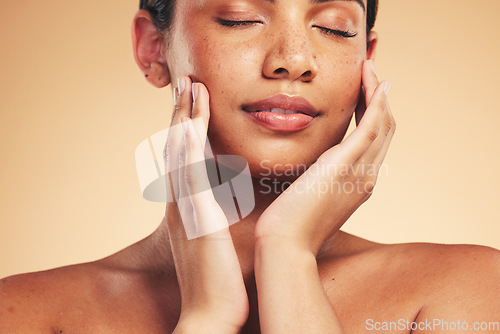 Image of Skincare, beauty and natural face of woman with hands for wellness, health and facial care in studio. Dermatology, spa and eyes closed of person on brown background in cosmetics, glow or satisfaction