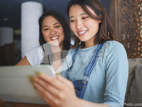 Image of Restaurant, tablet and Asian women for online menu, food options and order for lunch, meal or dinner. Coffee shop, cafe and happy friends on digital tech for social media review, website and app