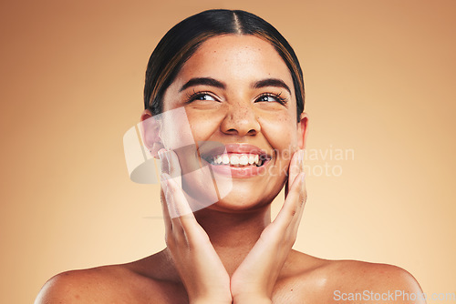 Image of Skincare, happy and hands on natural woman face in studio for cosmetic, wellness or dermatology on brown background. Beauty, smile and model excited for glowing skin, results or self love cosmetology