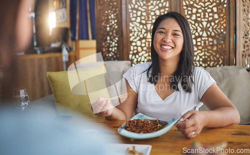 Image of Asian, food and woman on restaurant date eating for dinner or lunch meal using chopsticks and feeling happy with smile. Plate, young and person enjoy Japanese cuisine, noodles or diet at a table