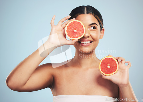 Image of Smile, skincare and woman in studio with grapefruit for natural skin beauty or wellness on grey background. Happy, fruit and female model with citrus cosmetics for vitamin c, collagen and exfoliate