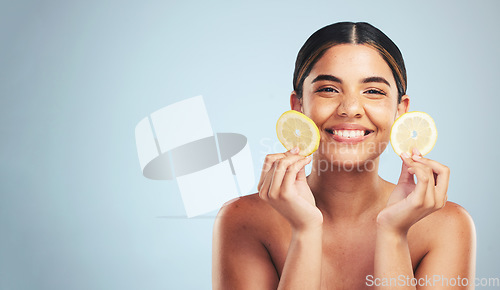 Image of Lemon, skincare and woman portrait in studio for vitamin C, wellness or organic, beauty or detox on grey background, Fruit, face and model smile for citrus facial, collagen or anti aging dermatology