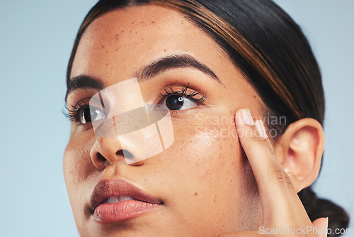 Image of Thinking, skincare or woman with beauty, cosmetics or dermatology on a blue studio background. Person, idea or model with wellness, self care or healthy skin with makeup, hygiene or natural treatment