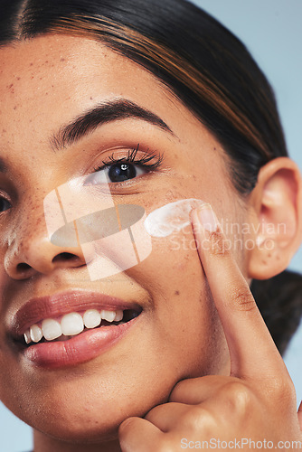 Image of Face, skincare cream and portrait of woman for aesthetic shine, dermatology and makeup cosmetics on studio background. Closeup, happy model and facial sunscreen lotion for self care, beauty and glow