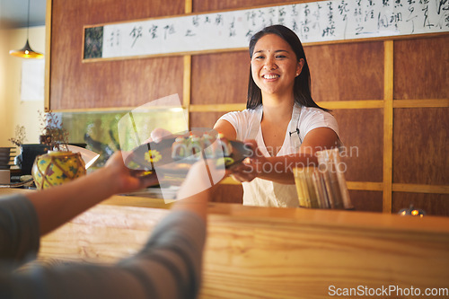 Image of Sushi chef, restaurant worker and woman with smile from food and Asian meal in a kitchen. Happy, female waiter or job working with fish menu for lunch order with cooking in Japanese bar with service