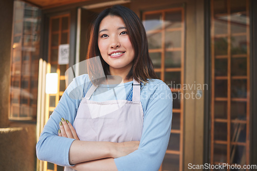 Image of Happy, waitress and Asian woman with arms crossed at restaurant, coffee shop or startup store. Idea, smile and confident barista, thinking employee or small business entrepreneur at cafe in Japan