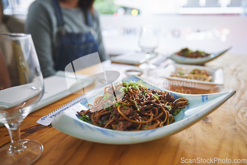 Image of Plate, eating and noodles at a restaurant on a table for Chinese food at lunch. Closeup, health and Asian cuisine for dinner, hungry or a meal at a fine dining cafe for a traditional snack or supper