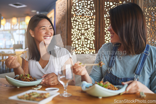 Image of Chopsticks, girl friends and funny joke with restaurant food, noodles and cafe happy from bonding. Asian women, eating and plate together with smile at a table hungry with lunch at Japanese bar