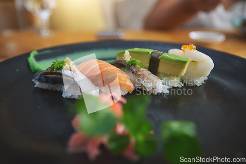 Image of Japanese, sushi and luxury food at a restaurant for dinner or lunch meal at a healthy Asian cafe on table. Plate, cuisine and fine dining takeaway or seafood from a Salmon menu for diet or nutrition