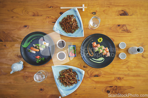 Image of Sushi restaurant, catering and plate in top view for service, lunch or dinner with soy sauce, chopsticks or fish. Japanese cuisine, platter and food in cafe, luxury and eating for nutrition in diet