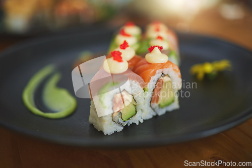 Image of Sushi restaurant, catering and plate in closeup for service, lunch and dinner for Philadelphia roll, chopsticks and fish. Japanese cuisine, platter and food in cafe, luxury and eating for nutrition