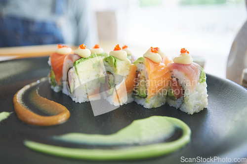 Image of Asian, sushi and plate of food at a restaurant for dinner or lunch meal at healthy Japanese cafe on table. Plate, cuisine and fine dining takeaway or seafood from a Salmon menu for diet or nutrition