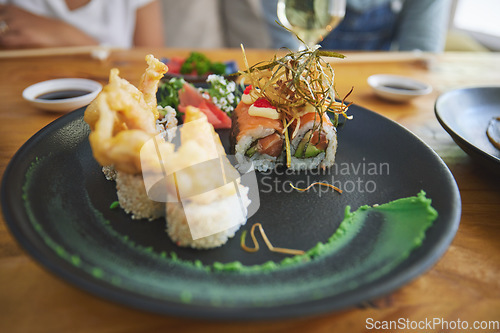 Image of Japanese, sushi and food at a restaurant for dinner or lunch meal at a healthy Asian cafe on table. Plate, cuisine and fine dining takeaway or seafood from a Salmon menu for diet or nutrition