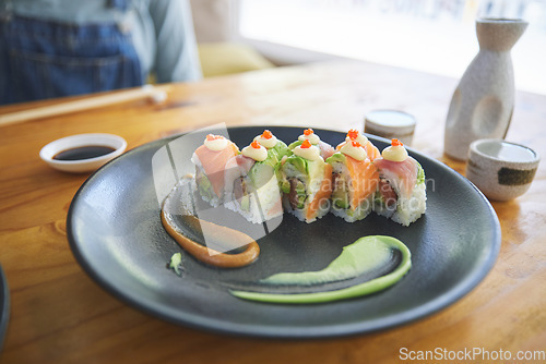 Image of Asian, sushi and luxury food at a cafe for dinner or lunch meal at a healthy Japanese restaurant on table. Plate, cuisine and fine dining takeaway or seafood from a Salmon menu for diet or nutrition