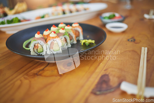 Image of Restaurant, meal and closeup of sushi on a plate for luxury, healthy and authentic Asian cuisine. Platter, fine dining and zoom of a Japanese food for lunch, dinner or supper at a traditional cafe.