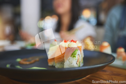 Image of Restaurant, food and closeup of sushi on a plate for luxury, healthy and authentic Asian cuisine. Platter, fine dining and zoom of a Japanese meal for lunch, dinner or supper at a traditional cafe.