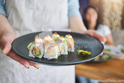 Image of Restaurant, hands and closeup of sushi on a plate for luxury, healthy and authentic Asian cuisine. Platter, fine dining and zoom of a Japanese meal for lunch, dinner or supper at a traditional cafe.