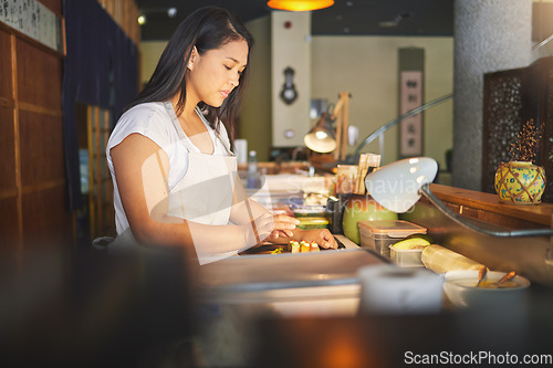 Image of Chinese food, cooking and an asian woman in a sushi restaurant to serve a traditional meal for nutrition. Kitchen, recipe and preparation with a young chef in an eatery for fine dining cuisine