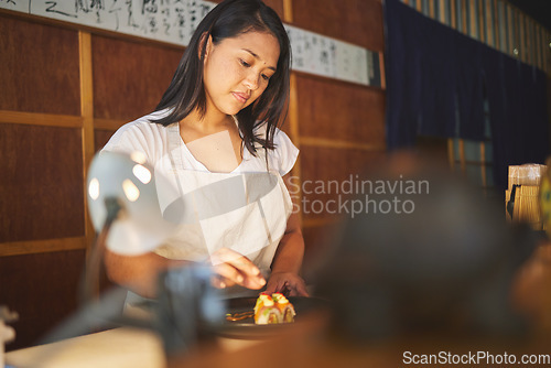 Image of Chinese food, recipe and an asian woman in a sushi restaurant to serve a traditional meal for nutrition. Kitchen, cooking or preparation with a young female chef in an eatery for fine dining cuisine