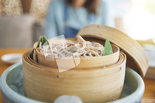 Image of Restaurant, steamer and closeup of a bowl of noodles for healthy Asian cuisine for diet. Food, bamboo pot and zoom of Japanese ramen for a nutrition meal for dinner, lunch or supper at a diner.