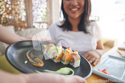 Image of Sushi plate, restaurant and hands of person, server or waiter with food choice, order or lunch for diner service. Hospitality industry, Japanese cuisine and cafeteria worker with meal for customer