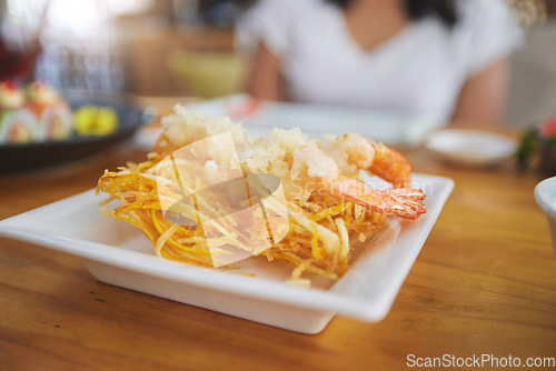 Image of Food, sushi and cuisine on a table in a restaurant for a traditional asian dish or meal closeup. Seafood, fine dining and shrimp tempura on a plate in a chinese eatery for hunger or nutrition