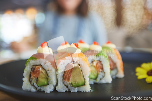 Image of Closeup, restaurant plate and sushi for lunch, eating seafood and Chinese food on bokeh. Zoom, health and a hungry person with a luxury fine dining dish of fish, Asian cuisine and dinner at a cafe