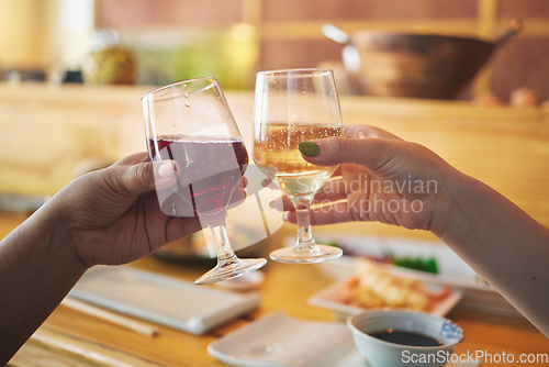 Image of Hands, wine glass and friends toast in restaurant in celebration together. Alcohol, cheers and people drink champagne in cafe store at party, bonding or fine dining at luxury event with food on table