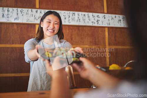 Image of Sushi, restaurant worker and happy woman with serving food and Asian meal in a kitchen. Plate, female waiter smile at job or chef working with fish recipe for lunch order with cooking in Japanese bar