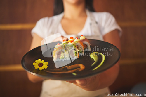 Image of Sushi plate, waiter hands and restaurant with service, helping and catering job in closeup. Small business, fast food server and cooking in cafe, startup diner and working with fish, rice or seaweed