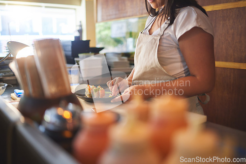 Image of Cooking, sushi and chef with hands of person in restaurant for seafood, Japanese cuisine and nutrition. Fish, lunch and health with closeup of woman in kitchen of store for menu, takeaway and diet